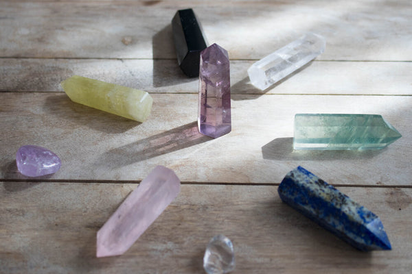 Close-up of a chakra wand with colorful crystals representing the seven chakras